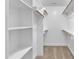 Spacious walk-in closet with shelving and hanging rods for optimal storage at 129 Davis St, Louisburg, NC 27549