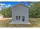 A view of the side and rear of the home, highlighting the siding and patio at 129 Davis St, Louisburg, NC 27549