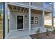 The lower level includes a black door, two windows, and a new welcome mat at 129 Davis St, Louisburg, NC 27549