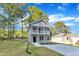Charming two-story home featuring a full front porch and a landscaped front yard at 129 Davis St, Louisburg, NC 27549