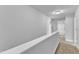Second floor hallway leading to bathroom with glass door shower at 129 Davis St, Louisburg, NC 27549