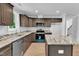 Modern kitchen featuring dark wood cabinets, granite countertops, and stainless steel appliances at 129 Davis St, Louisburg, NC 27549