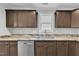 Granite countertops and dark wood cabinets in the modern kitchen provide style and function at 129 Davis St, Louisburg, NC 27549