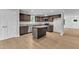 Modern kitchen featuring dark wood cabinets, granite countertops, and stainless steel appliances at 129 Davis St, Louisburg, NC 27549