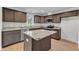 Modern kitchen featuring dark wood cabinets, granite countertops, and stainless steel appliances at 129 Davis St, Louisburg, NC 27549