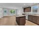 Modern kitchen with granite countertops, stainless steel appliances, and a center island at 129 Davis St, Louisburg, NC 27549