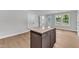 Kitchen island with seating in an open concept kitchen with lots of natural light at 129 Davis St, Louisburg, NC 27549