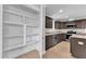 Kitchen with pantry, stainless steel appliances and granite countertops at 129 Davis St, Louisburg, NC 27549
