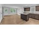 Open concept kitchen with dark wood cabinets, granite countertops, and lots of floor space at 129 Davis St, Louisburg, NC 27549