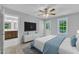 Comfortable main bedroom featuring a ceiling fan, an ensuite bath and a window with a view at 129 Davis St, Louisburg, NC 27549