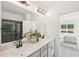 Modern bathroom with double vanity, quartz countertop, sleek fixtures, large mirror, and green-tiled shower at 1410 Malcus Ct # 55, Fuquay Varina, NC 27526