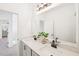 Bright bathroom featuring double sinks, modern fixtures, a large mirror and stylish cabinets at 1410 Malcus Ct # 55, Fuquay Varina, NC 27526