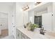 Modern bathroom with double vanity, quartz countertop, sleek fixtures, large mirror and decorative plant for an elevated look at 1410 Malcus Ct # 55, Fuquay Varina, NC 27526