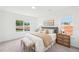 Sun-filled bedroom featuring a plush bed with decorative pillows and throw, flanked by woven nightstands and cozy bench at 1410 Malcus Ct # 55, Fuquay Varina, NC 27526