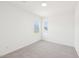 Bright carpeted bedroom with two windows offers serene views and ample natural light at 1410 Malcus Ct # 55, Fuquay Varina, NC 27526