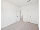 An empty bedroom features neutral carpet, two doors, and a blank canvas ready for personal touch at 1410 Malcus Ct # 55, Fuquay Varina, NC 27526