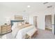 Sun-filled bedroom featuring a plush bed with decorative pillows and throw, flanked by woven nightstands and cozy bench at 1410 Malcus Ct # 55, Fuquay Varina, NC 27526