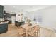 Open-concept dining area with a wooden table, chairs, and a view of the kitchen island at 1410 Malcus Ct # 55, Fuquay Varina, NC 27526