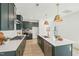 Spacious kitchen featuring dark green cabinetry, quartz countertops, and stainless steel appliances at 1410 Malcus Ct # 55, Fuquay Varina, NC 27526