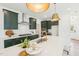 Stylish kitchen with dark green cabinets, stainless steel appliances, and a spacious island with seating at 1410 Malcus Ct # 55, Fuquay Varina, NC 27526