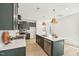 Well-designed kitchen with dark green cabinets, a stainless steel dishwasher, and pendant lighting at 1410 Malcus Ct # 55, Fuquay Varina, NC 27526