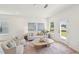 Inviting living room with a cozy sofa, armchairs, and a large window showcasing the outdoor view at 1410 Malcus Ct # 55, Fuquay Varina, NC 27526