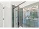 Elegant bathroom featuring green tile shower with modern glass door, sleek fixtures, and bright natural light at 1410 Malcus Ct # 55, Fuquay Varina, NC 27526