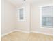 A well-lit bedroom with two windows and neutral walls and carpet at 149 Wards Ridge Dr, Cary, NC 27513