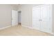 This is an airy bedroom with neutral walls, carpet, and double door closet at 149 Wards Ridge Dr, Cary, NC 27513