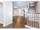 Spacious living room with hardwood floors, a staircase, and large windows providing ample natural light at 149 Wards Ridge Dr, Cary, NC 27513