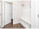 Convenient mudroom area with a built-in bench, coat hooks, and shelving for easy organization at 149 Wards Ridge Dr, Cary, NC 27513