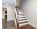 Elegant staircase with wood treads and white risers, creating a focal point in the home's design at 149 Wards Ridge Dr, Cary, NC 27513