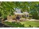 Charming backyard with a stone patio, dining area, grill, well-manicured lawn and lush green surroundings at 150 Georgetown Woods Dr, Youngsville, NC 27596