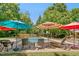A backyard pool with lounge chairs, umbrellas and table for backyard outdoor enjoyment and relaxation at 150 Georgetown Woods Dr, Youngsville, NC 27596