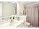 Well-lit bathroom featuring a vanity with a large mirror, sink, and neutral decor at 150 Georgetown Woods Dr, Youngsville, NC 27596