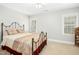 Comfortable bedroom with neutral walls, carpet flooring, and natural light from windows at 150 Georgetown Woods Dr, Youngsville, NC 27596