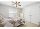 Cozy bedroom with a comfortable bed, ceiling fan, and double door closet at 150 Georgetown Woods Dr, Youngsville, NC 27596