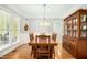 Elegant dining room showcasing a wooden table, stylish chandelier, and large windows for natural light at 150 Georgetown Woods Dr, Youngsville, NC 27596