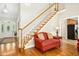 Bright entryway leads to stairs with wood handrail and trim plus views into the kitchen and front door at 150 Georgetown Woods Dr, Youngsville, NC 27596