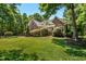 Charming brick home with a lush green lawn, mature trees, and well-maintained landscaping at 150 Georgetown Woods Dr, Youngsville, NC 27596