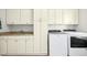 Well-organized laundry room with cabinets, counter space, and modern washer and dryer at 150 Georgetown Woods Dr, Youngsville, NC 27596