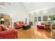 Bright living room featuring hardwood floors, a vaulted ceiling, and French doors leading to an outdoor space at 150 Georgetown Woods Dr, Youngsville, NC 27596