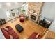 Spacious living room featuring a stone fireplace, hardwood floors, and ample natural light at 150 Georgetown Woods Dr, Youngsville, NC 27596
