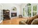 Cozy living room with a fireplace and large windows for plenty of natural light at 150 Georgetown Woods Dr, Youngsville, NC 27596