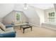Upstairs bonus room with seating, carpet, and natural light from windows at 150 Georgetown Woods Dr, Youngsville, NC 27596