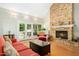 Inviting living room boasting a stone fireplace, hardwood floors, and French doors to the backyard at 150 Georgetown Woods Dr, Youngsville, NC 27596