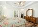 A main bedroom with tray ceilings, wood floors, and a dresser at 150 Georgetown Woods Dr, Youngsville, NC 27596