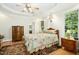 Large main bedroom with tray ceilings, wood floors, and lots of natural light at 150 Georgetown Woods Dr, Youngsville, NC 27596