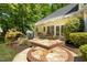 Charming outdoor patio with stone paving, dining set, grill, and beautiful landscaping, perfect for outdoor entertaining at 150 Georgetown Woods Dr, Youngsville, NC 27596