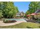 Refreshing pool area with lounge chairs and lush green landscaping, perfect for relaxation at 150 Georgetown Woods Dr, Youngsville, NC 27596